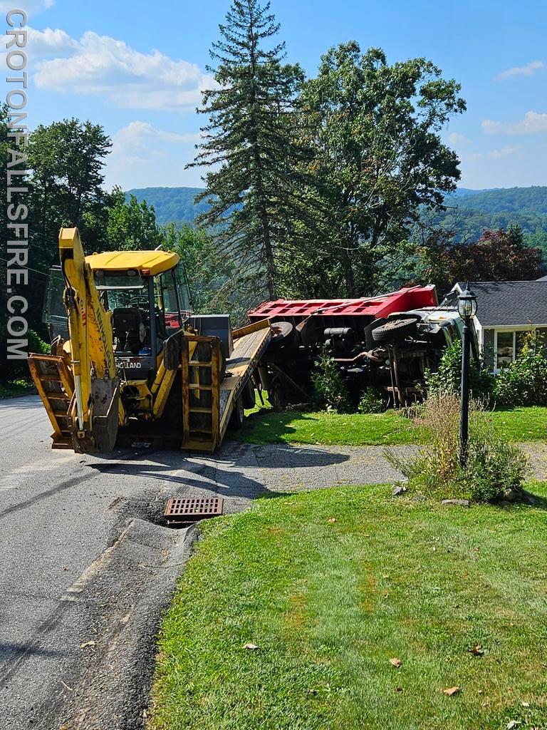 Rollover while loading a machine on a trailer on Westview Cross Road, 09/06/23